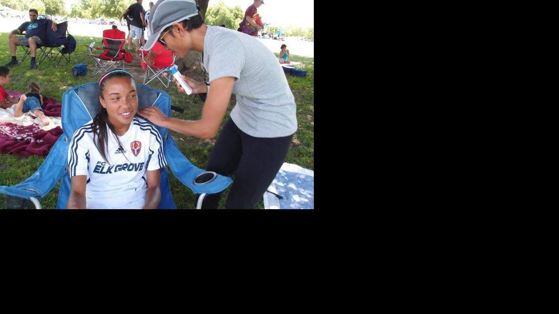 
Thresa McDonald applies sunscreen to her daughter, Tai, then 12, at the Cherry Island Soccer Complex in Antelope. Tai was playing for Elk Grove United in the annual Cal Cup youth soccer tournament in 2012. Elk Grove is seeking to build its own sports complex to serve youth and professional soccer teams.
