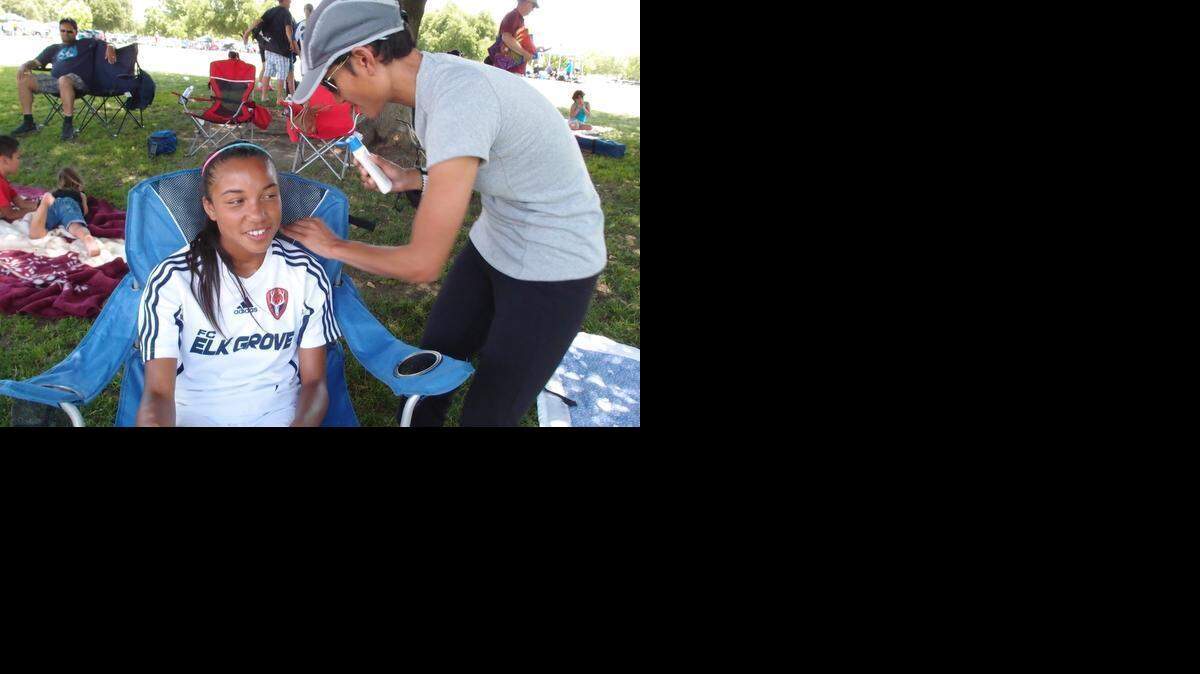 
Thresa McDonald applies sunscreen to her daughter, Tai, then 12, at the Cherry Island Soccer Complex in Antelope. Tai was playing for Elk Grove United in the annual Cal Cup youth soccer tournament in 2012. The Elk Grove City Council is moving to annex land to build its own sports complex to serve youth and professional soccer teams.
