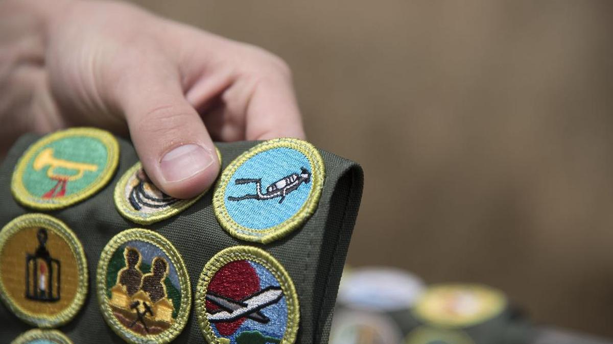 Bingham shows off his scuba diving merit badge, which he said is the one he is most proud of, on June 7 in El Dorado Hills.