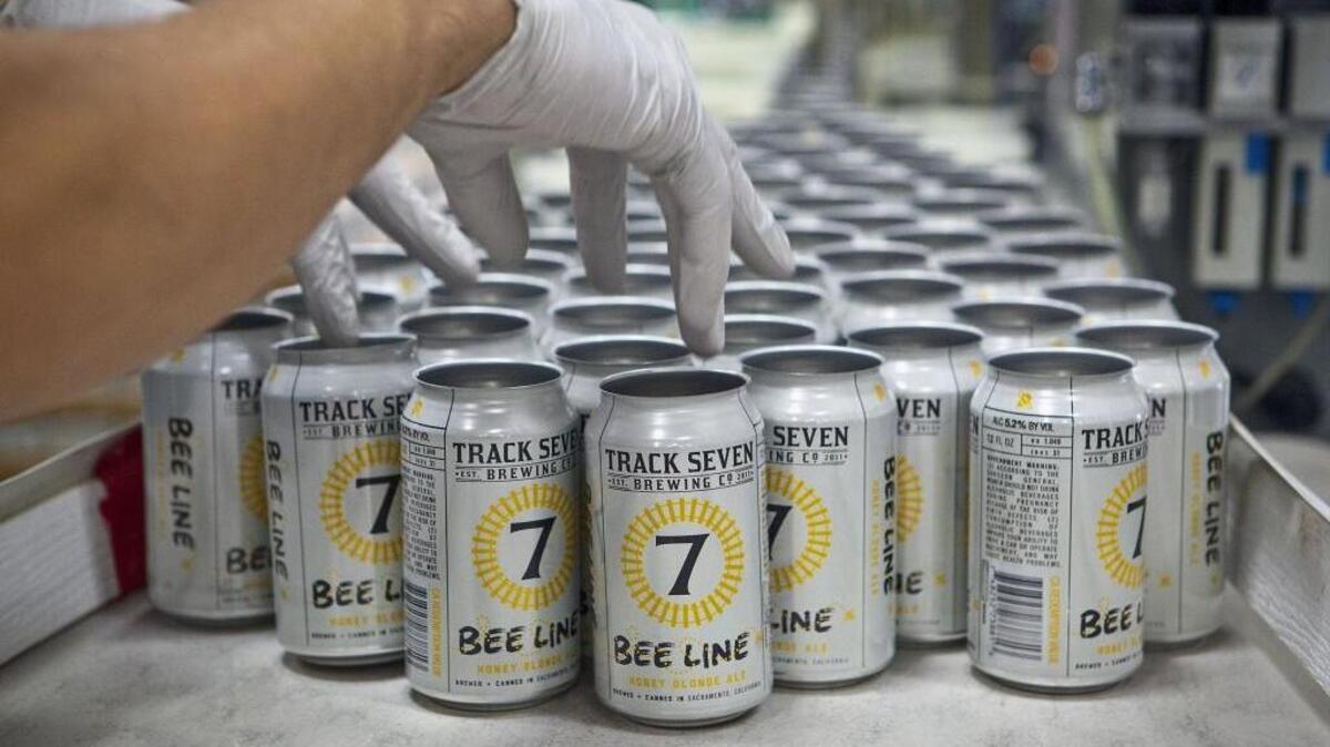 Empty beer cans are loaded onto a mobile canning line at Track 7 Brewing Co.’s Natomas facility on Sept. 13, 2015. Even though cans have made a major push into craft beer in recent years, bottles are still the most common packaging format.