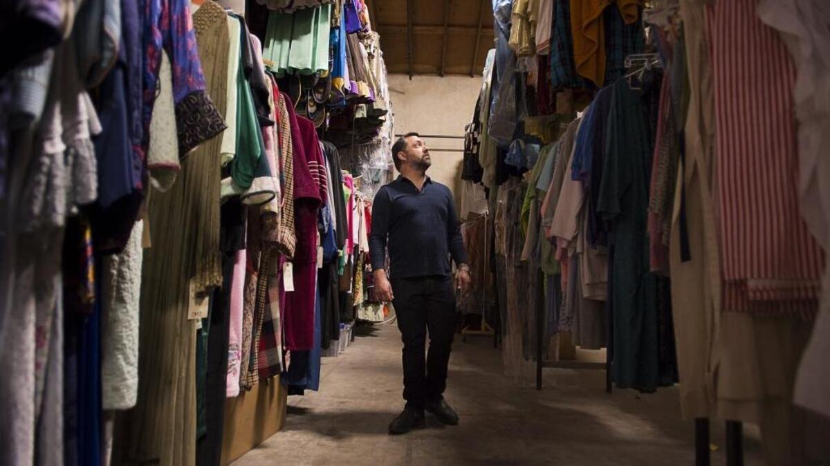 Music Circus artistic director Scott Klier looks at the hundreds of costume stored in the prop room of the Music Circus Theatre on June 5 in Sacramento.