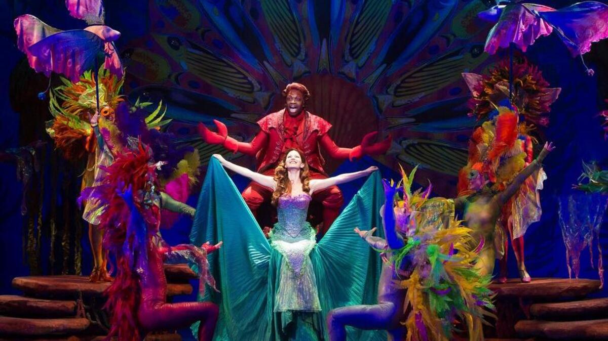 Melvin Abston as Sebastian and Alison Woods as Ariel perform with the cast of “The Little Mermaid.”