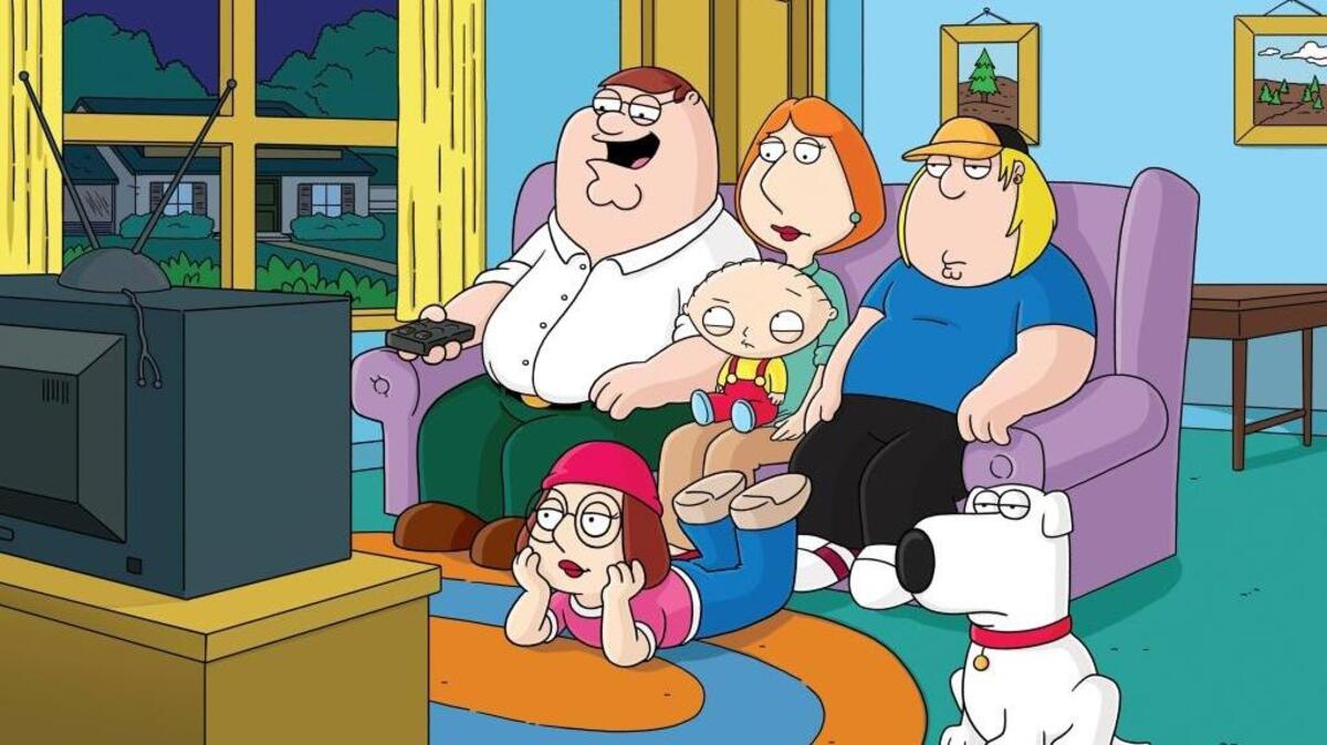 The Griffin family members from the Fox animated series “Family Guy” are shown. From left are Peter, Lois, Stewie (on her lap), Meg (on the ground), Chris and Brian (dog).