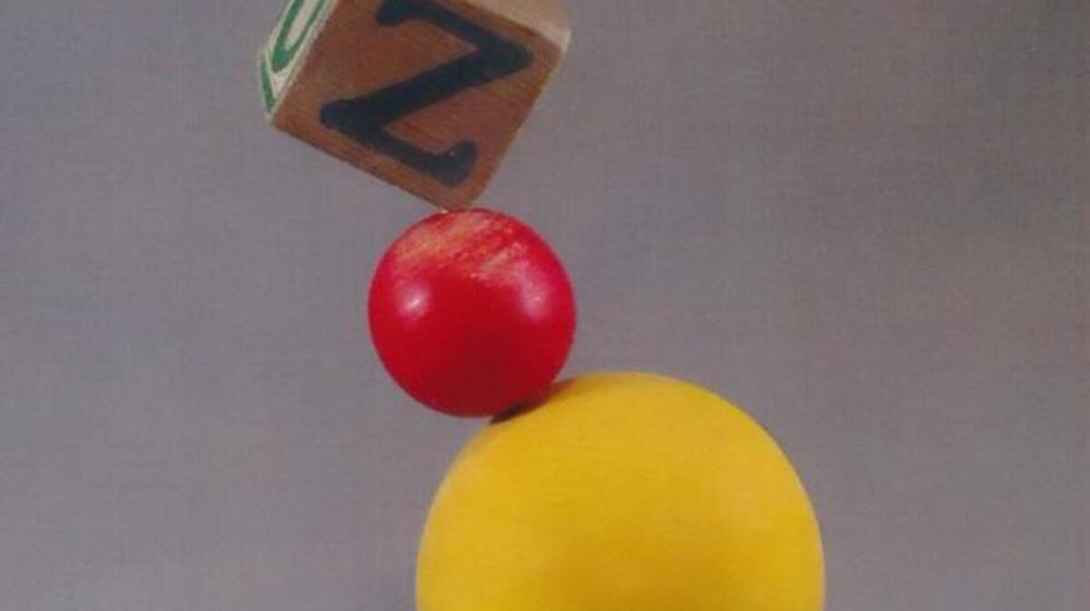 A wooden sculpture that’s part of the “Large Thoughts – Little Packages” exhibit by Roy Tatman at Artspace1616.
