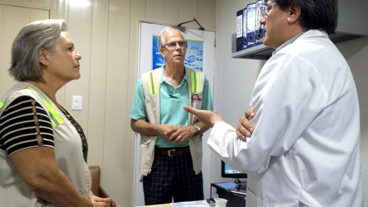 Volunteer wardens Berit and Dan Wick talk with Dr. Martin Caravajal at a hospital in Cartagena, Colombia, that takes care of many American travelers.