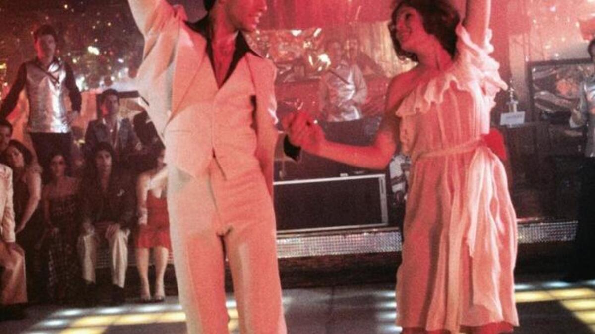 John Travolta and Karen Lynn Gorney in “Saturday Night Fever,” which returns to theaters nationwide May 7 and 10.