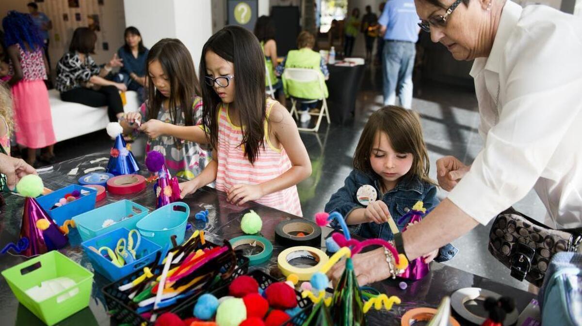
From left, Vivian Lin, 7, Katie Locke, 8, and Chloe Lanterman, 5, with grandmother Marilyn Cottini, all of Sacramento, decorate party hats at the five-year celebration for the Crocker Art Museum expansion in downtown Sacramento on Saturday, Oct. 10, 2015.

