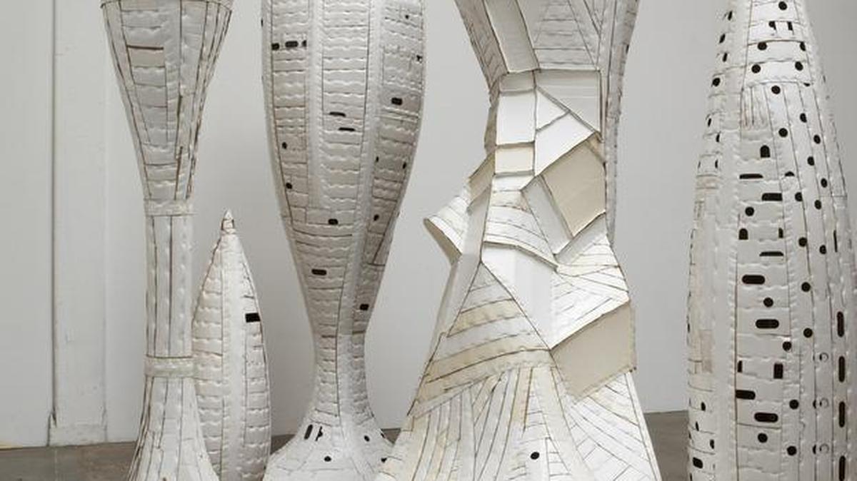 Ann Weber’s “The Wedding Party,” 2009, found cardboard, staples, polyurethane, (seven pieces) size variable from 96 to 10 inches,