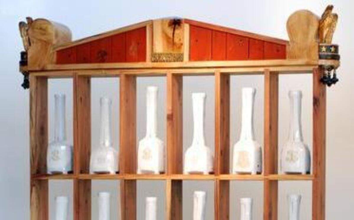 
“Cabinet #1,” part of Trent Burkett’s show of sculptures, “Misc,” is a series of porcelain bottles set in a large wooden china cabinet that mixes colonial federalist elements with Asian grace notes. The porcelain bottles are carved into graceful tall shapes whose necks are slit open, emphasizing that they are only partially functional. The base of the cabinet is painted with Chinese red lacquer while the ceramic vessels are influenced by Japanese clay works. Each of the bottles is marked with a European-style monogram adding to the cultural mix that the piece embodies. “Misc” runs 11 a.m.-4 p.m. Wednesday-Saturday through March 28 at Jay Jay, 5520 Elvas Ave. in Sacramento.
