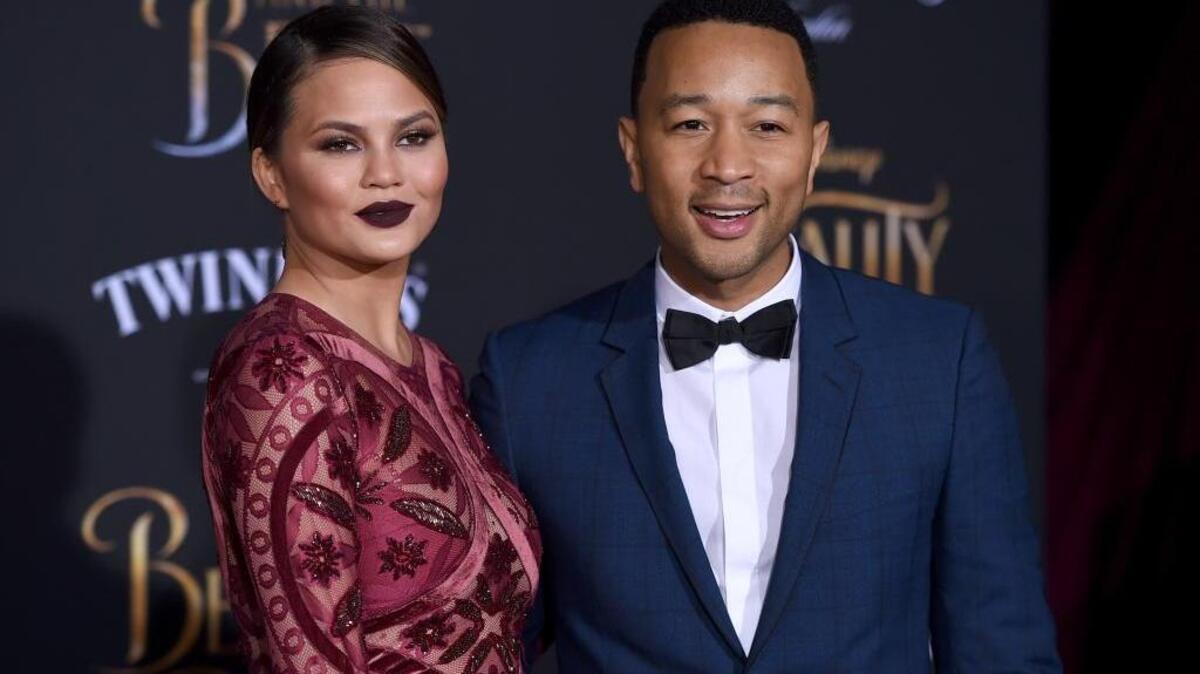 In this March 2, 2017 file photo, Chrissy Teigen, left, and John Legend arrive at the world premiere of "Beauty and the Beast" at the El Capitan Theatre in Los Angeles.