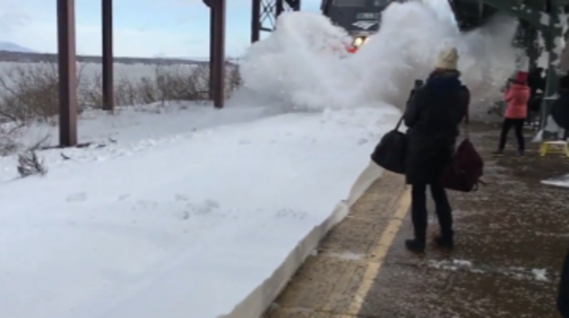 Watch train blast bystanders with a wall of snow