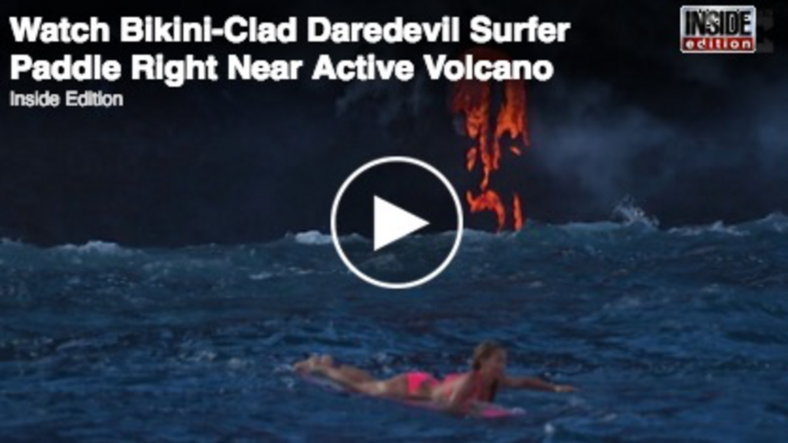 Watch daredevil female surfer paddle near active volcano