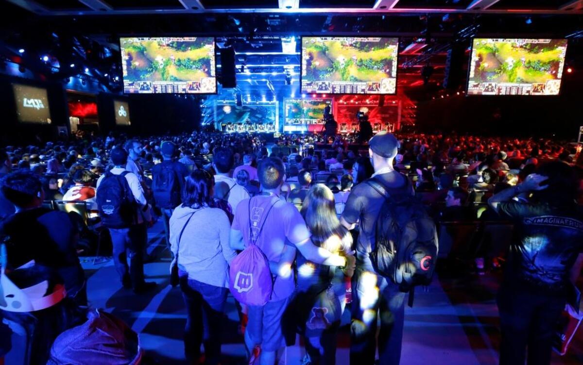 Hundreds of spectators fill an exhibition hall to watch a round of the “League of Legends” championship series in this 2014 file photo.