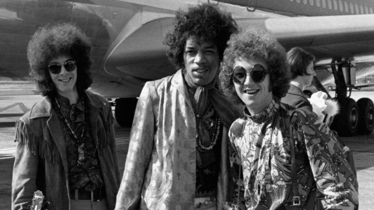 Jimi Hendrix, center, is seen with bass guitarist Noel Redding, left, and drummer Mitch Mitchell at London’s Heathrow Airport in August 1967. The men were members of the band The Jimi Hendrix Experience.
