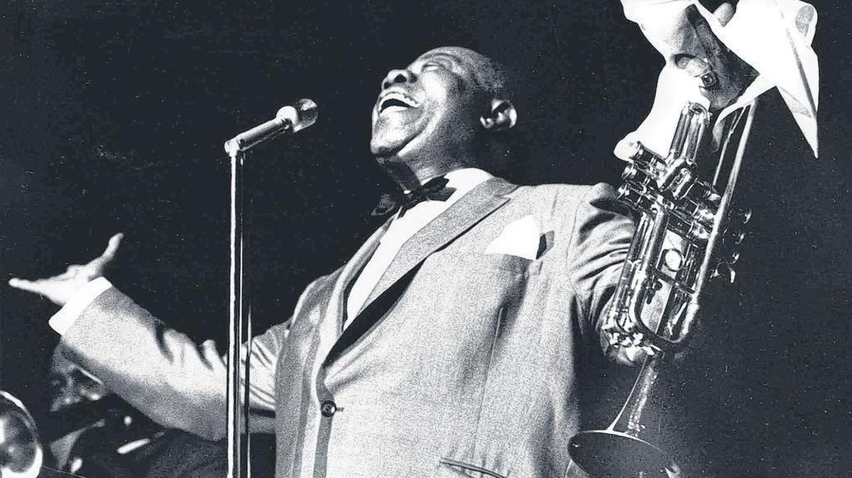 Jazz great Louis Armstrong gestures to the crowd at the Atlanta Jazz Festival in Atlanta, in this June 6, 1966 photo.