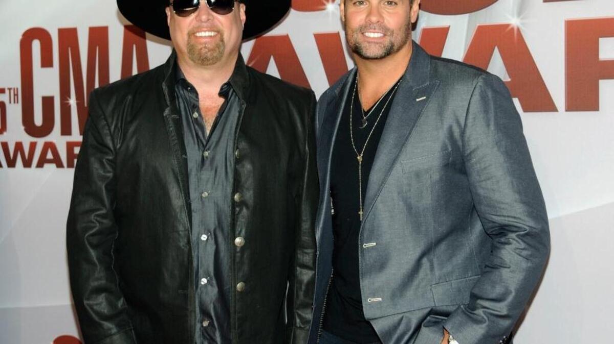 FILE - In this Nov. 9, 2011 file photo, Eddie Montgomery, left, and Troy Gentry of Montgomery Gentry arrive at the 45th Annual CMA Awards in Nashville, Tenn. Gentry, one half of the award-winning country music duo Montgomery Gentry, died Friday, Sept. 8, 2017, in a helicopter crash, according to a statement from the bandâs website. He was 50. The group was supposed to perform Friday at the Flying W Airport & Resort in Medford, N.J.