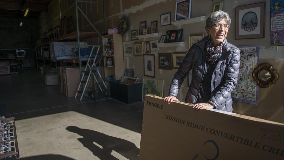 Volunteer Ginny Allen loads a new crib for a family in need at the Furniture for Families warehouse in Rancho Cordova. Furniture for Families is a nonprofit organization that provides household furnishings to low-income families in need. They are asking Book of Dreams to donate money to buy new cribs for their clients.