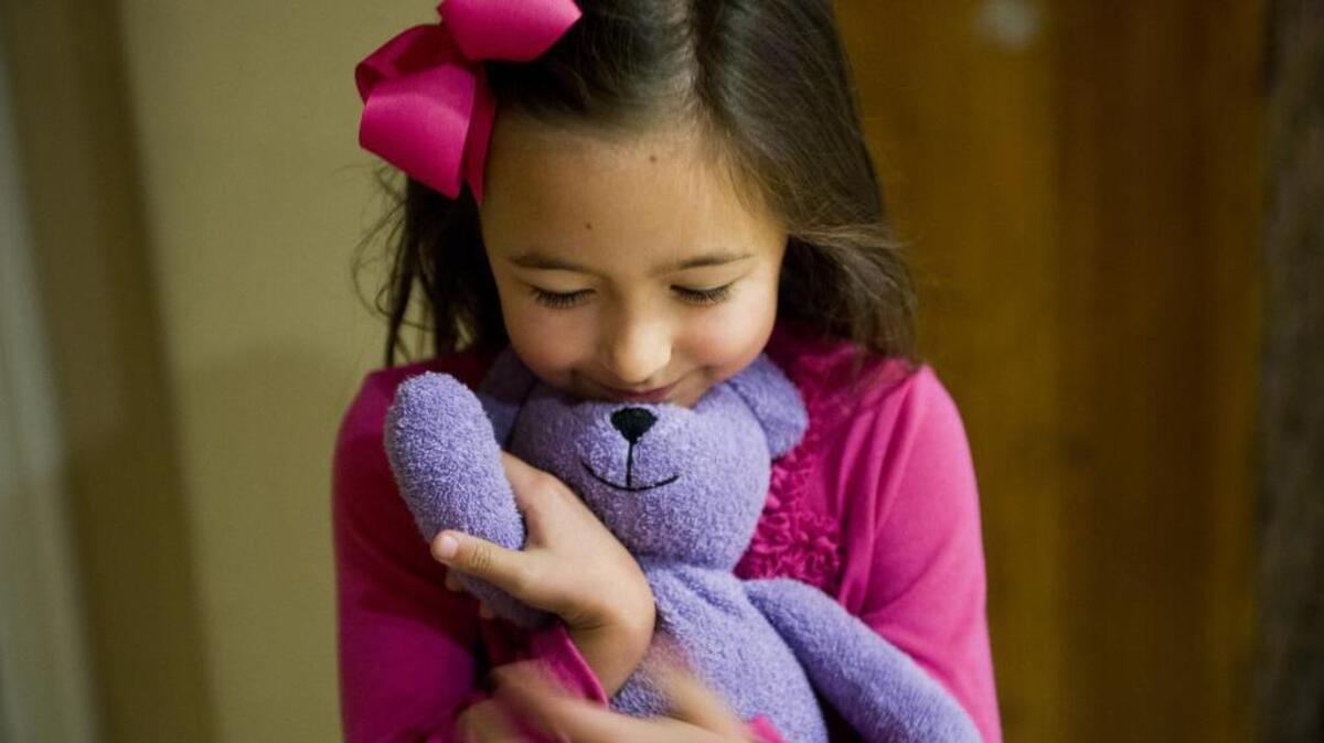 
Macy Coad, 5, hugs her thermal bear, that she’s named “Princess Plums.” Macy has Juvenile arthritis and must take a large amount of medication and weekly shots to keep it under control. Book of Dreams readers are asked to donate money to buy backpacks that the local Arthritis Foundation will give to children afflicted with Juvenile arthritis. The backpacks contain educational material and special thermal bears which are stuffed animals that heat up in the microwave and help ease the pain for children.

