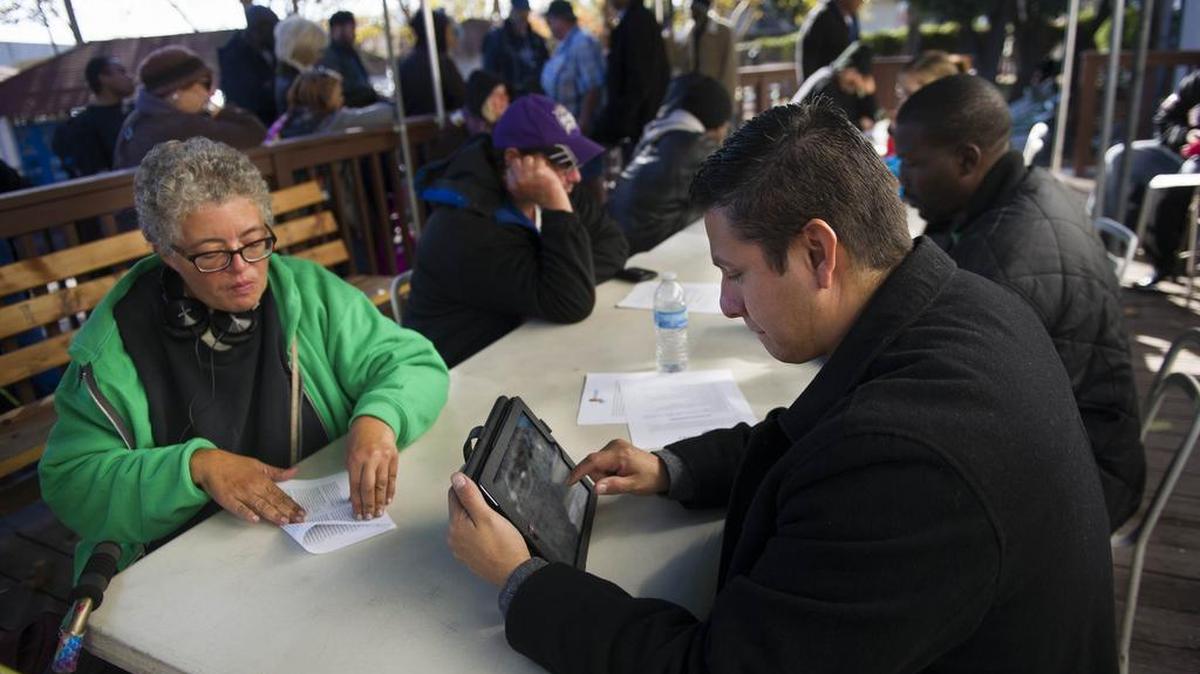 Tom Platina of Capital Christian Center volunteers his time to help check-in patrons looking to seek shelter with the Winter Sanctuary program on Monday, Nov. 24, 2014, in Sacramento, Calif. Mega church pastor Rick Cole’s stint on the streets raised $166,000 for winter housing for the homeless, but the program still needs $100,000 to achieve its goal of busing, feeding and housing as many as 100 people each night in rotating houses of worship.