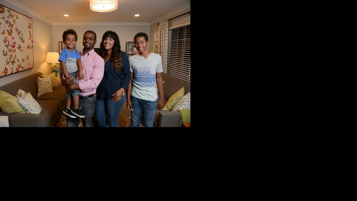
Avery, Hasani, Katrina and Tabari Sullivan gather in their living room of their rebuilt home.
