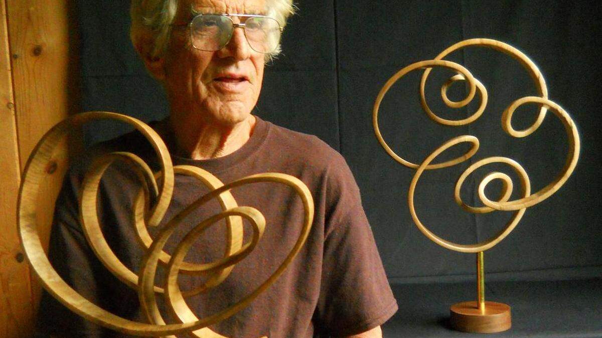 Sculptor John McAbery with two of his recent creations.