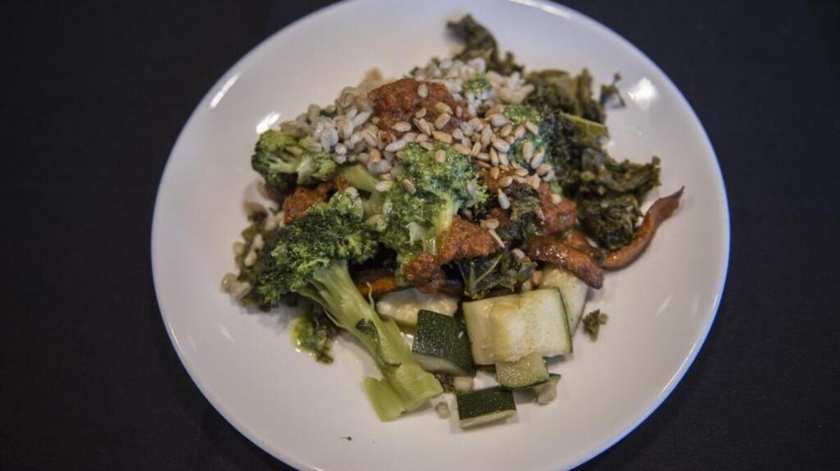 CalSTRS Executive Chef Conrad Caguimbal offers a salad with roasted vegetables from the pension fund’s edible garden featured every day in the CalSTRS cafeteria in West Sacramento.