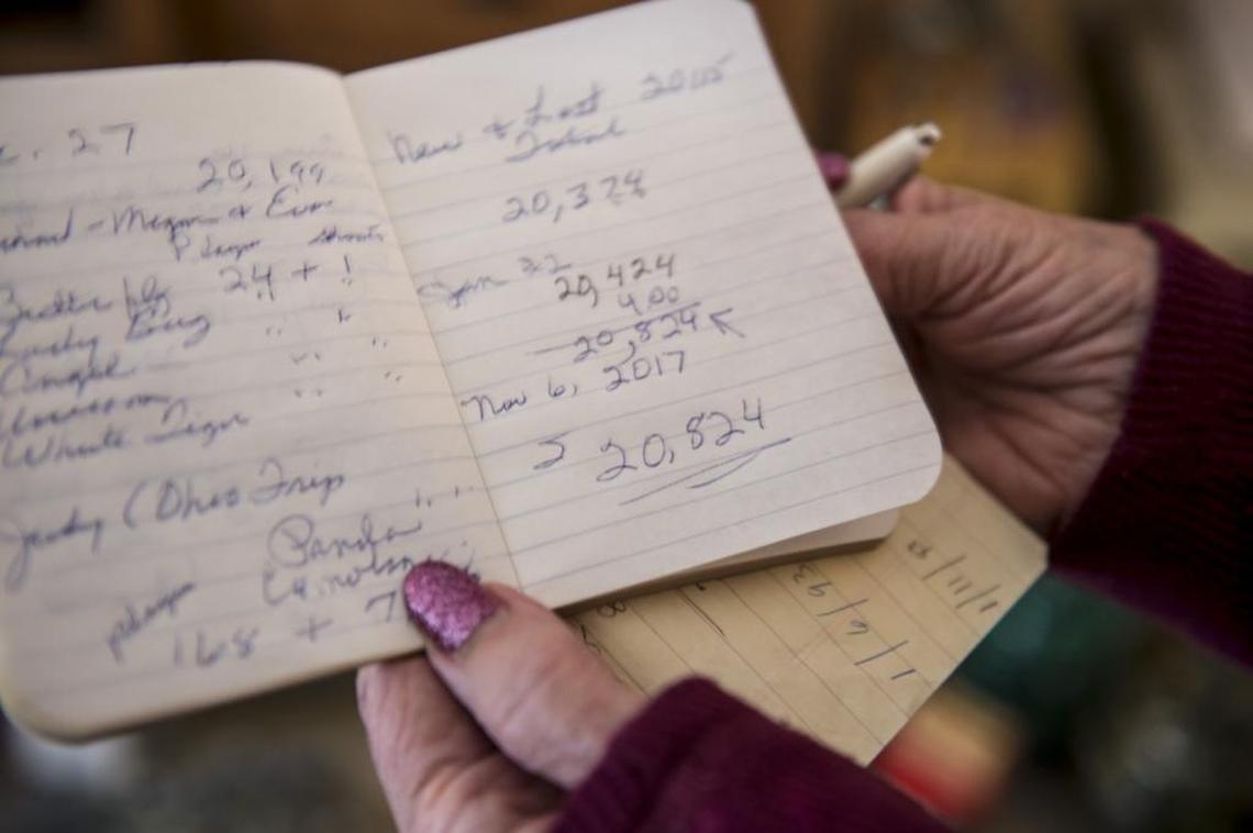 Judy Headley shows off her book where she has been recording notes about her marble collection since 1992. Her last count was 20,824 marbles.