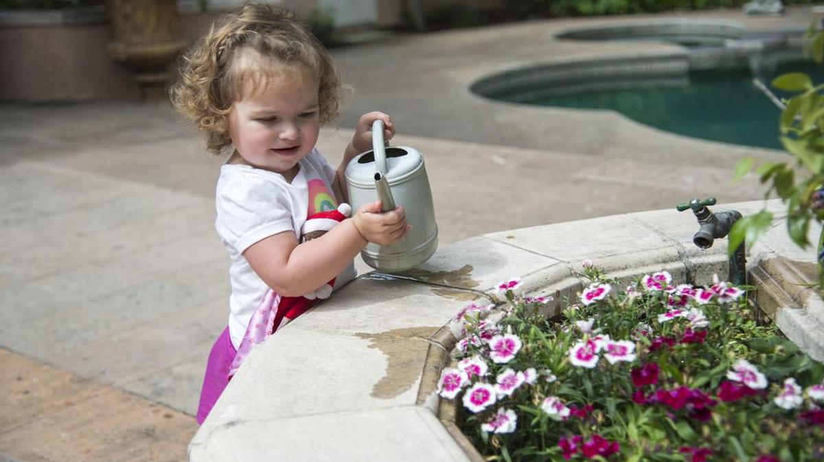 Alice Montelius waters a potted plant at the Lubin home in East Sacramento, Thursday, April 21, 2016. The East Sacramento Garden Tour has become a Mother's Day weekend tradition, with the 2026 garden tour scheduled for this Saturday and Sunday.