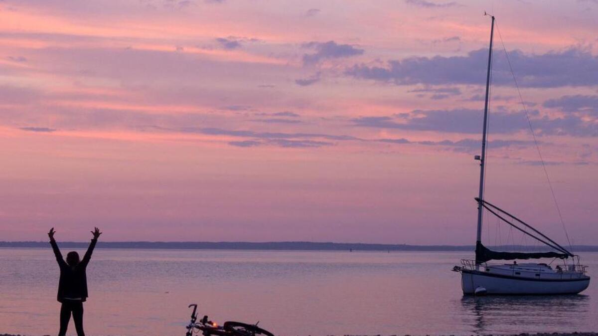 
"It's beautiful. I had to stop," said Kristie Hughes of Washington, D.C. about pulling over on her bike to practice yoga at sunset in Vineyard Haven, Mass. Vineyard Haven is located on Martha's Vineyard. Originally from New Haven, Hughes was vacationing with her family. (Patrick Raycraft/Hartford Courant/MCT)
