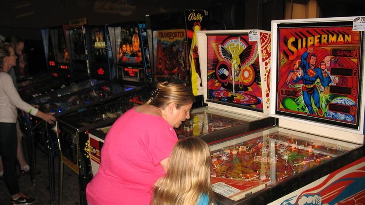 Attendees play a Super Man-themed pinball machine at 2016’s California Extreme.