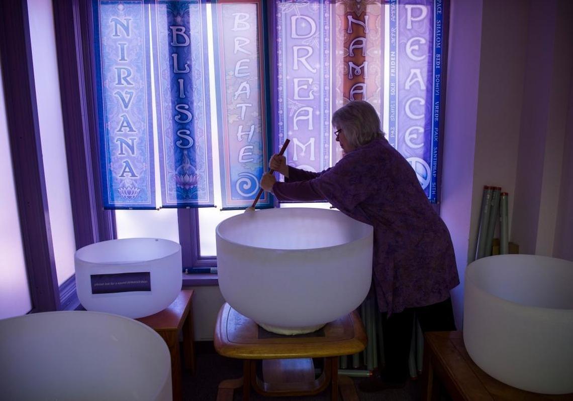 Dee Sponsler, an employee with Soul Connections in the town of Mount Shasta, plays crystal singing bowls in the store on April 29. Mount Shasta’s giant peak, the largest in north America, is a mountain of mystery, attracting spiritual questers from across the globe.