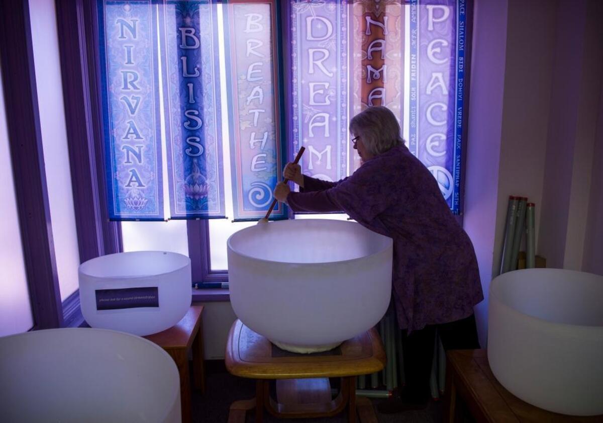 Dee Sponsler, an employee with Soul Connections in the town of Mount Shasta, plays crystal singing bowls in the store on April 29. Mount Shasta’s giant peak, the largest in north America, is a mountain of mystery, attracting spiritual questers from across the globe.