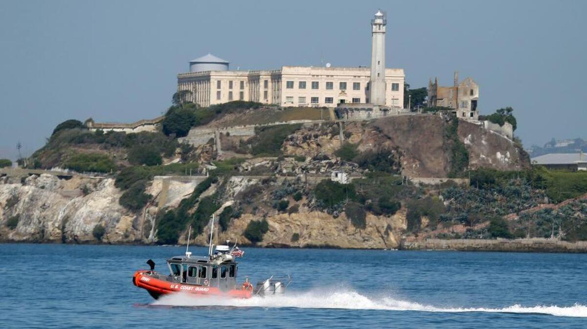 A U.S. Coast Guard boat goes past Alcatraz Island, which is part of the U.S. National Parks Service.
