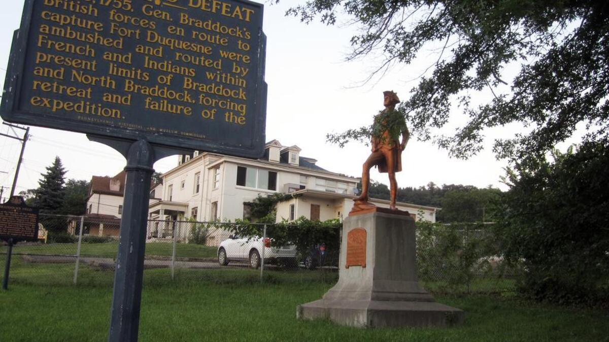 In North Braddock, Penn., a statue of George Washington stands behind a marker near where forces of British Gen. Edward Braddock were defeated at the Battle of the Monongahela.