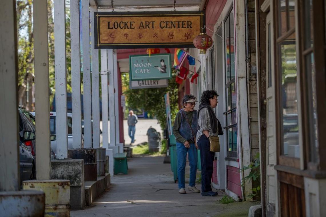 Virginia Coyle, left, and her sister Elizabeth Ung peer through the windows of Main street on Thursday, March 24, 2016, in Locke, Calif. Locke, the last remaining rural Chinese town in the United States, lies along the Sacramento River Delta.