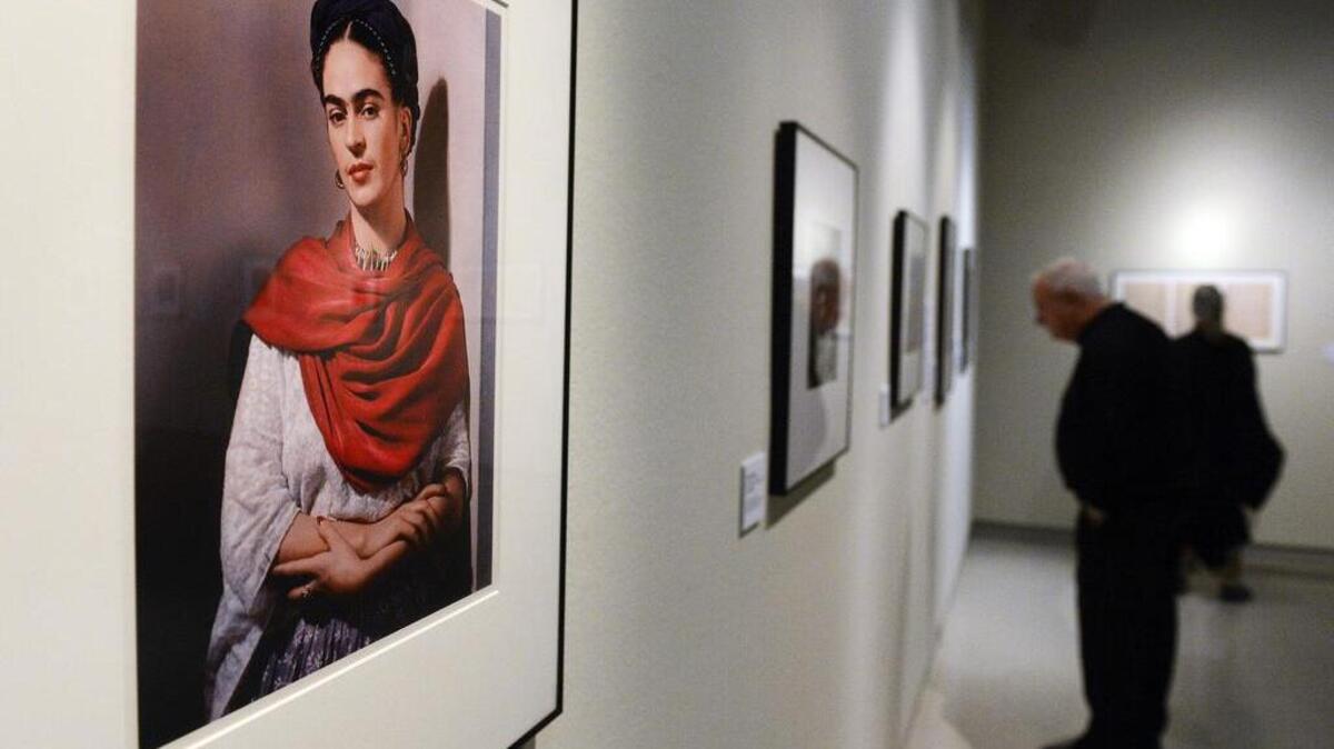 Visitors peruse Nickolas Muray photographs of Frida Kahlo on the opening night of the Fresno Art Museum's winter-spring exhibitions, Friday, Jan. 22, 2016. A standing room-only crowd filled the Bonner Auditorium for a gallery talks panel discussion and took part in the following reception for the exhibits that also featured works by Anne Scheid, Sonia Romero, Richard G. Freitas as well as the Fresno State Women RAD show. The exhibit continues until May 1.