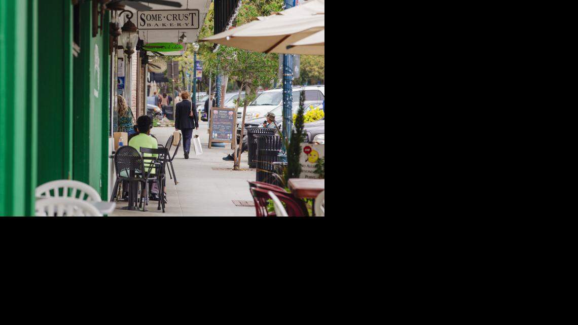 
People stroll and socialize along Yale Avenue in Claremont Village earlier this month.
