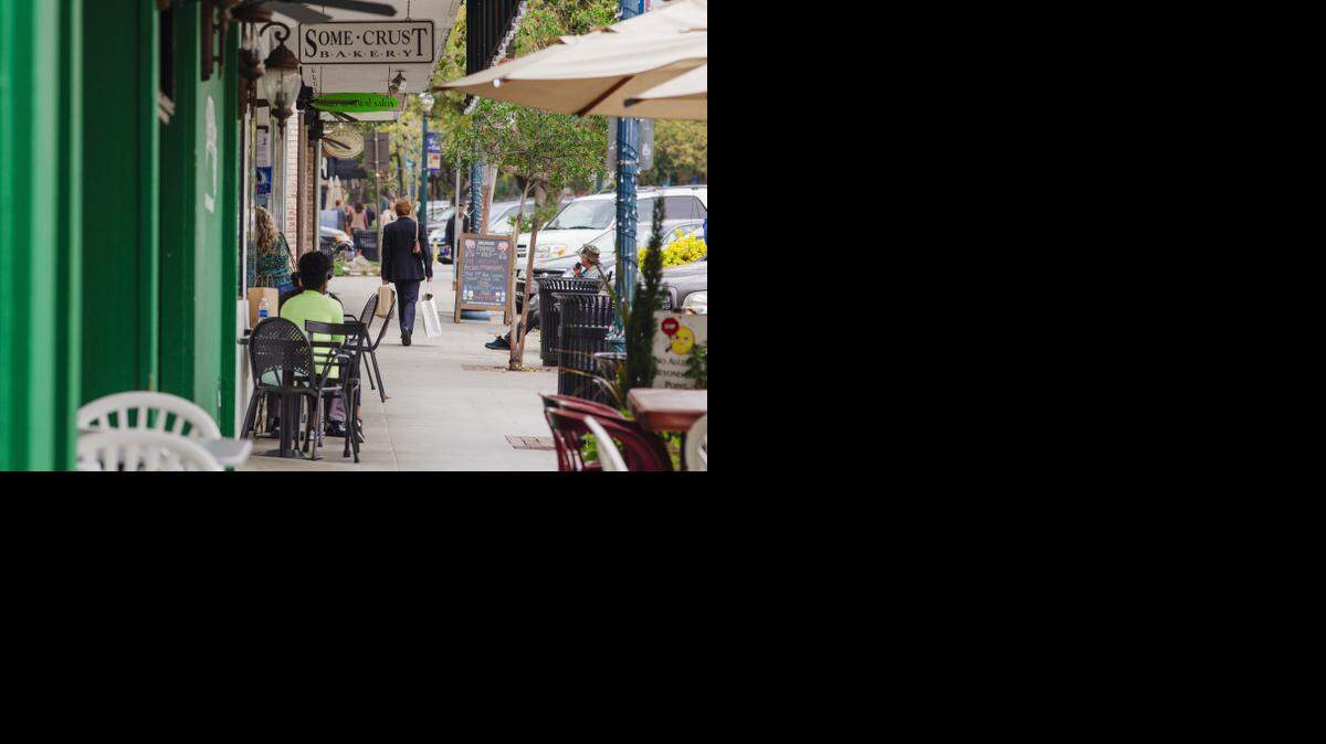 
People stroll and socialize along Yale Avenue in Claremont Village earlier this month.
