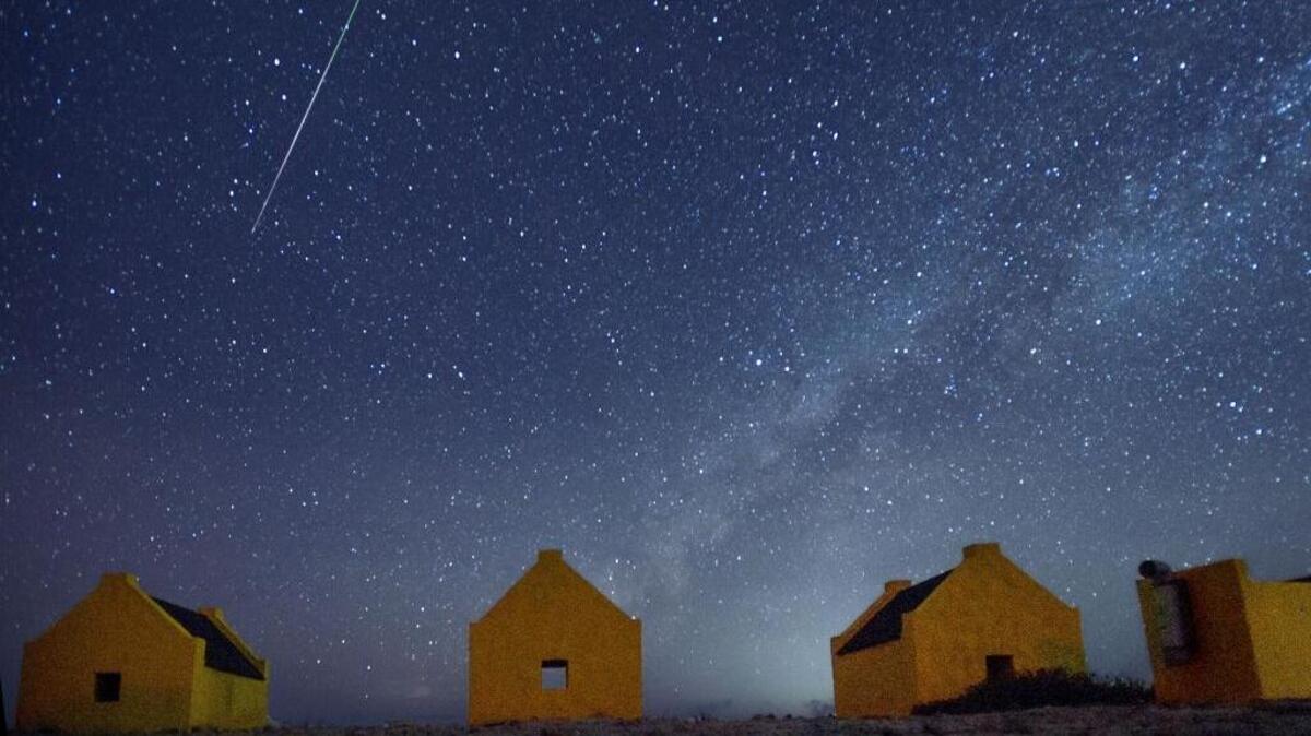
A meteor streaks across the sky over the Red Slave huts in Bonaire at 3:12 am on Thursday, Aug. 13, 2015. The meteor was one of the many in the annual Perseid meteor shower. The huts are hundreds of years old and are remnants of the days when slave labor was used on the island.
