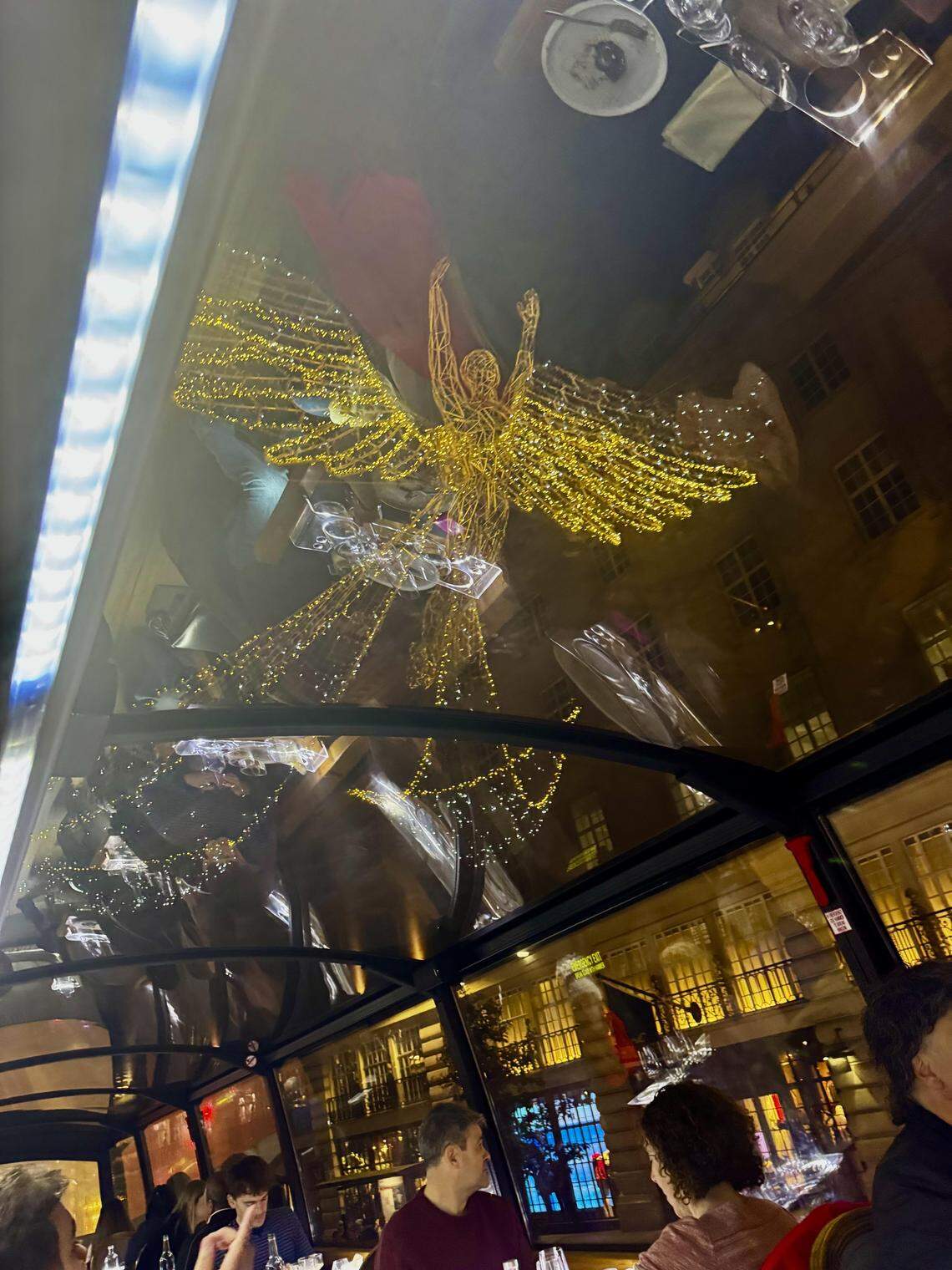 Guests dine aboard Bustronome’s glass-roofed gourmet bus to see London’s lights in comfort.