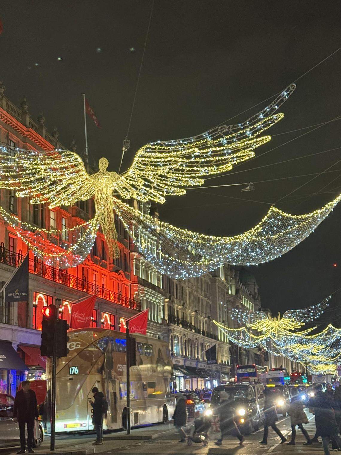 Regent Street glowing with its signature angel lights during the holiday season.