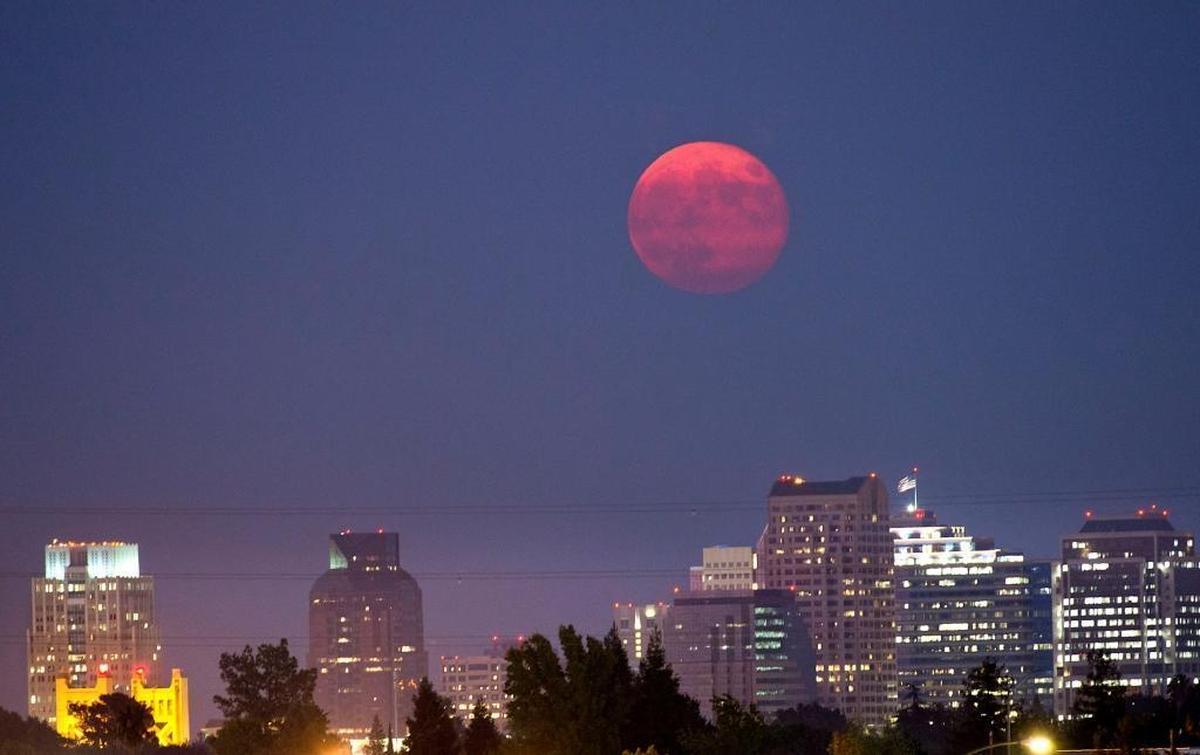 The moon rises over the Sacramento skyline on Sept. 9, 2014.