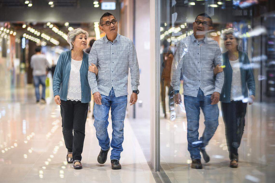 A happy senior couple walking at the mall.