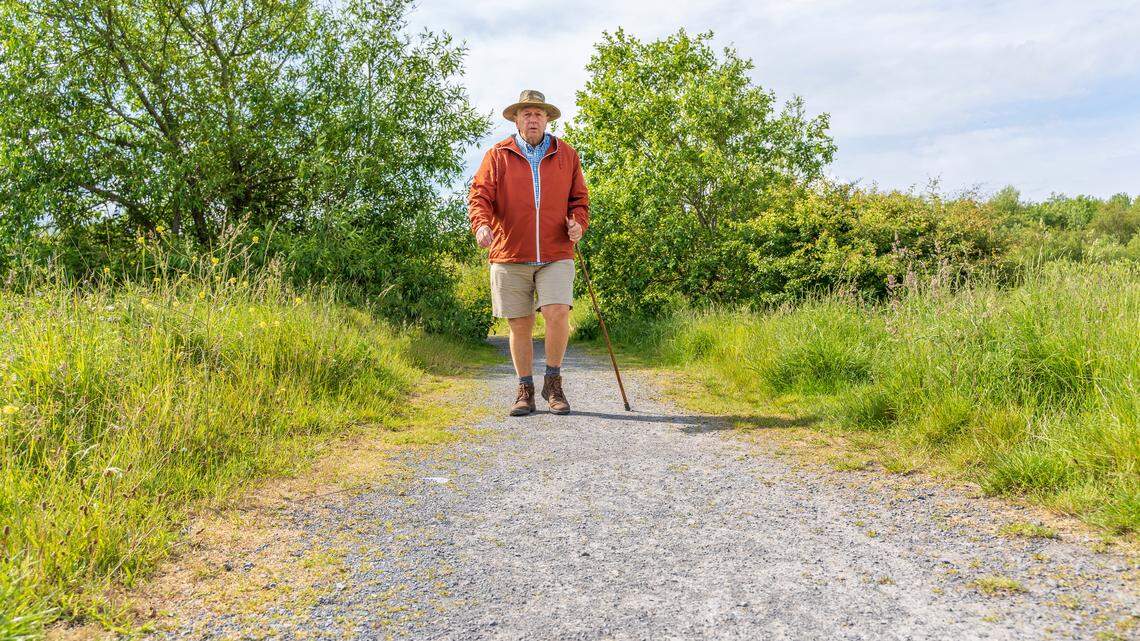 Active senior man hiking in countryside.