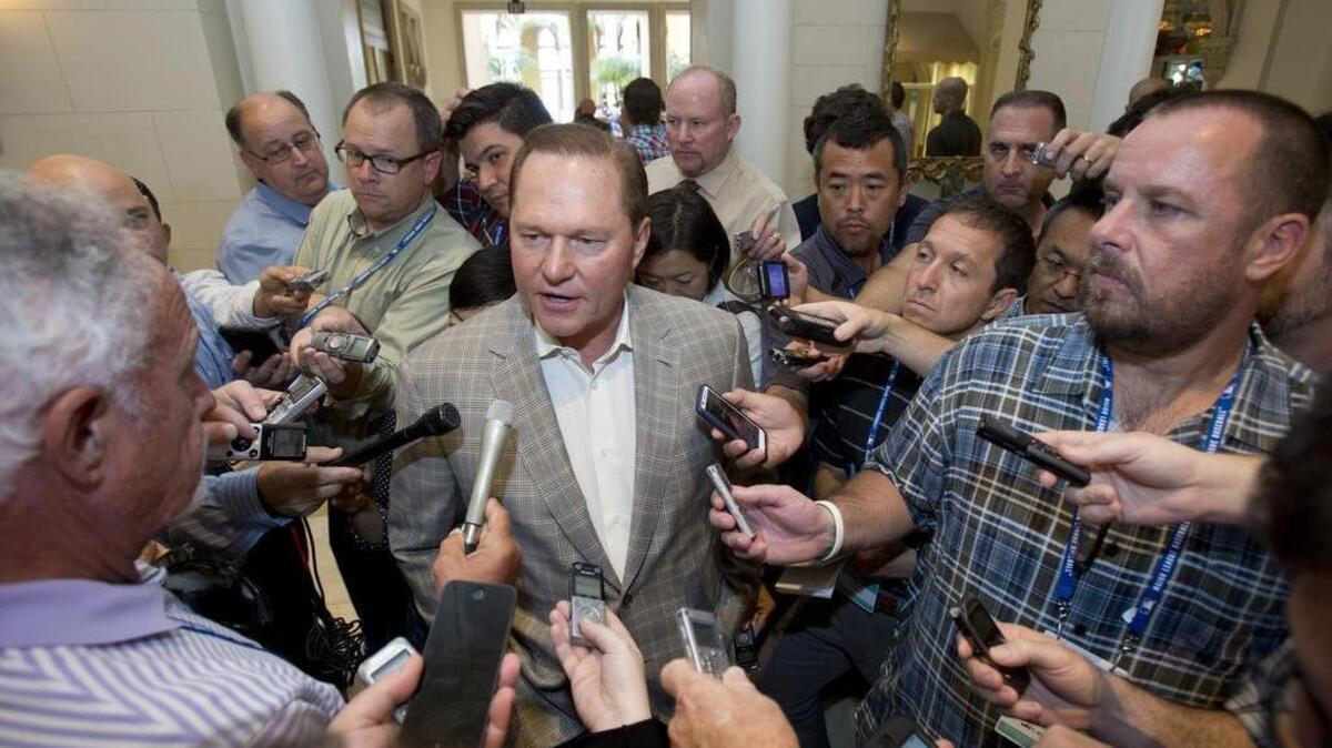 Sports agent Scott Boras, center, speaks to reporters at the baseball general managers' meetings, Wednesday, Nov. 11, 2015, in Boca Raton, Fla.