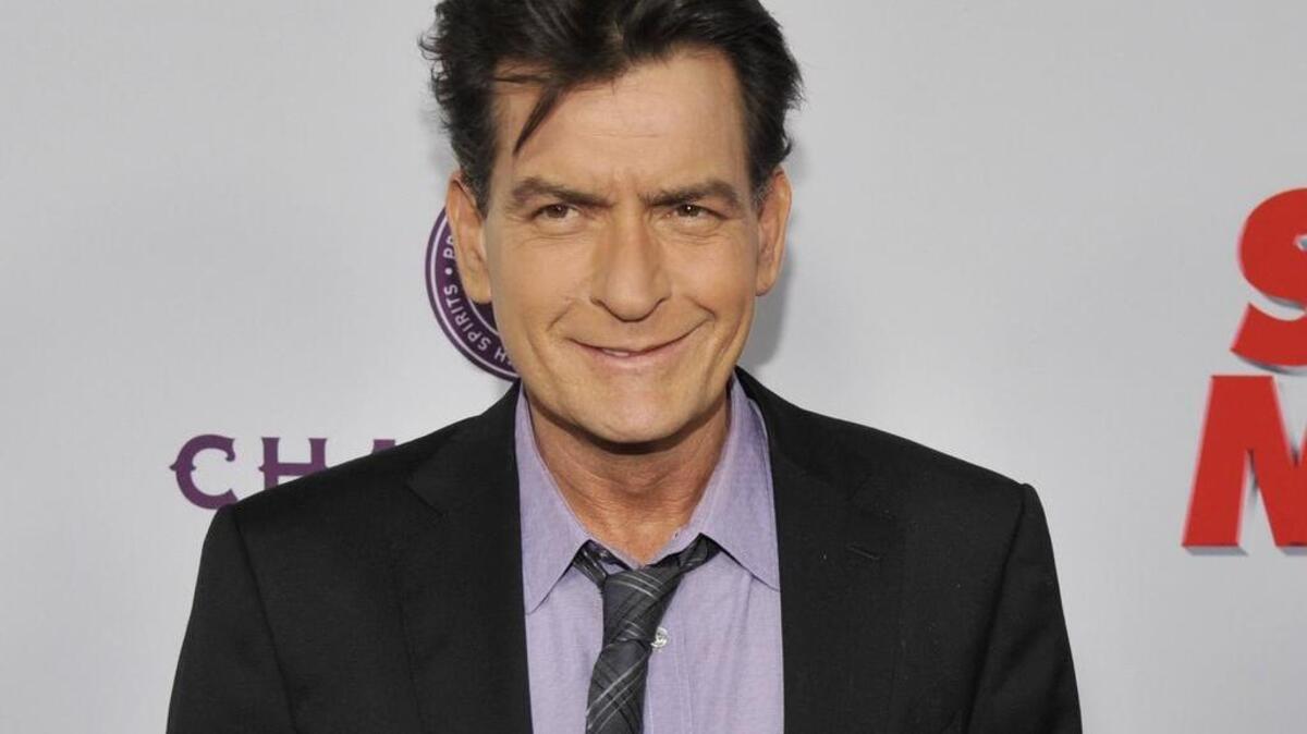 In this April 11, 2013 file photo, Charlie Sheen, a cast member in "Scary Movie V," poses at the Los Angeles premiere of the film at the Cinerama Dome in Los Angeles.