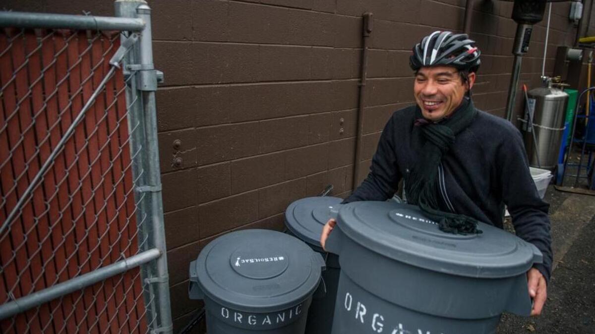 David S. Baker, founder of Gras, collects food waste at Selland’s Market Cafe in Sacramento in 2014. Gras picks up compostable food scraps from restaurants and delivers the compost to local area farms and throughout the community to promote natural, organic use of soil and sustainability.
