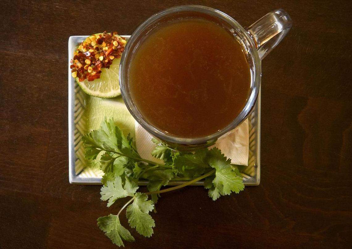 The beef broth served with cilantro, parsley and chile lime at Backbone Café.