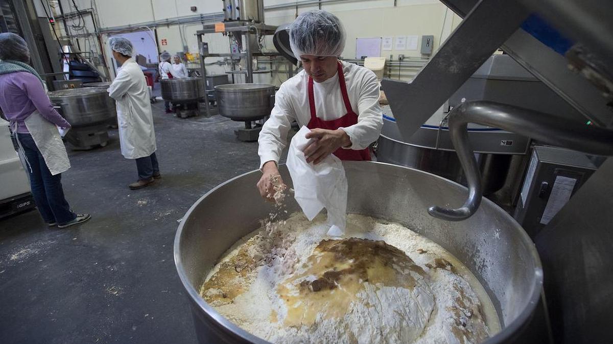 Production worker Gilberto Castro adds ingredients into a large mixing bowl at United Bakery in West Sacramento earlier this month. The business has plans to move to a larger facility.