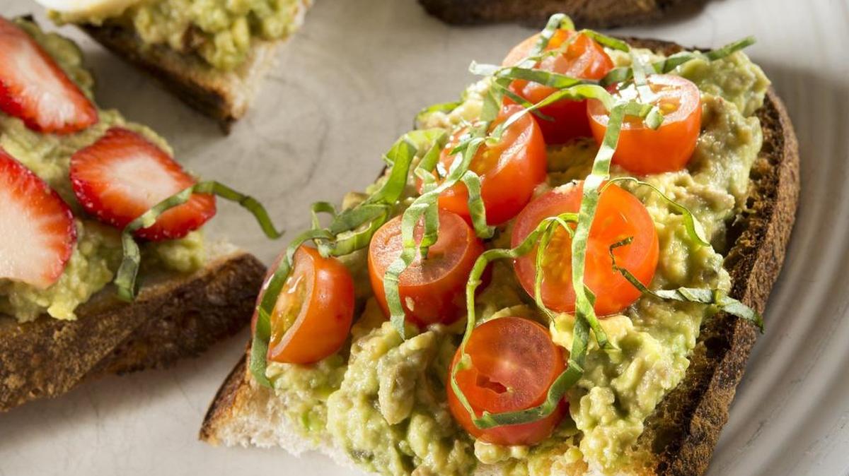 Avocado toast with cherry tomatoes and basil.